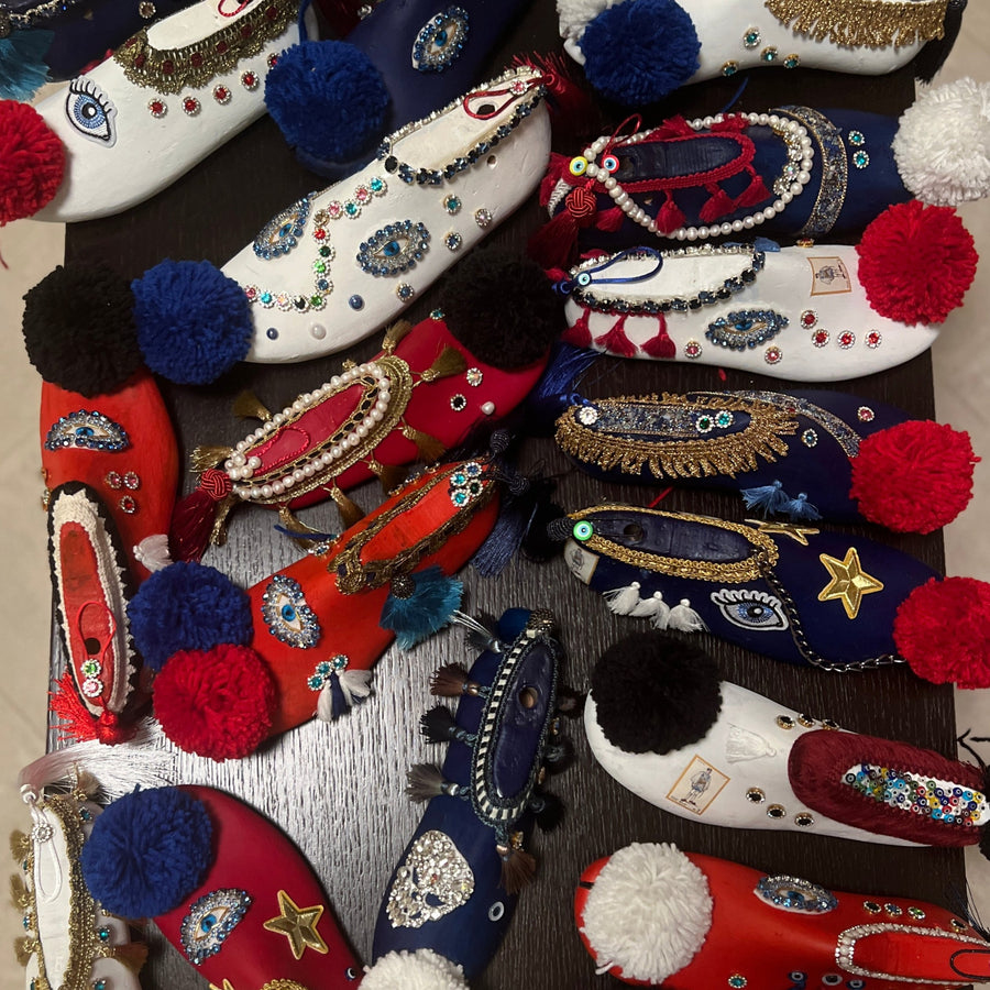 Collection of handmade tsarouchia folk-art shoe sculptures with pom-poms
