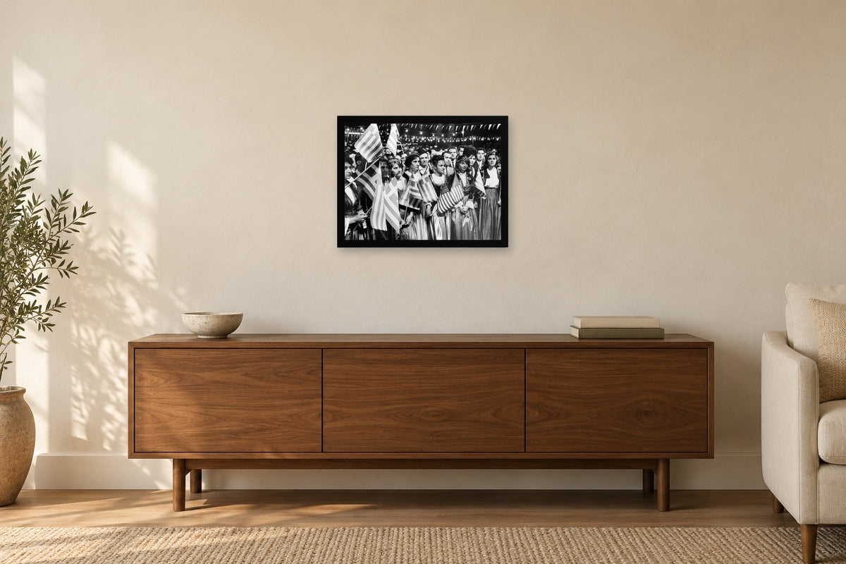 Two Flags, One Community in a black frame, shown in a home setting — room visualization