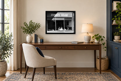 Zorba’s House Storefront in a black frame, shown in an office setting — room visualization