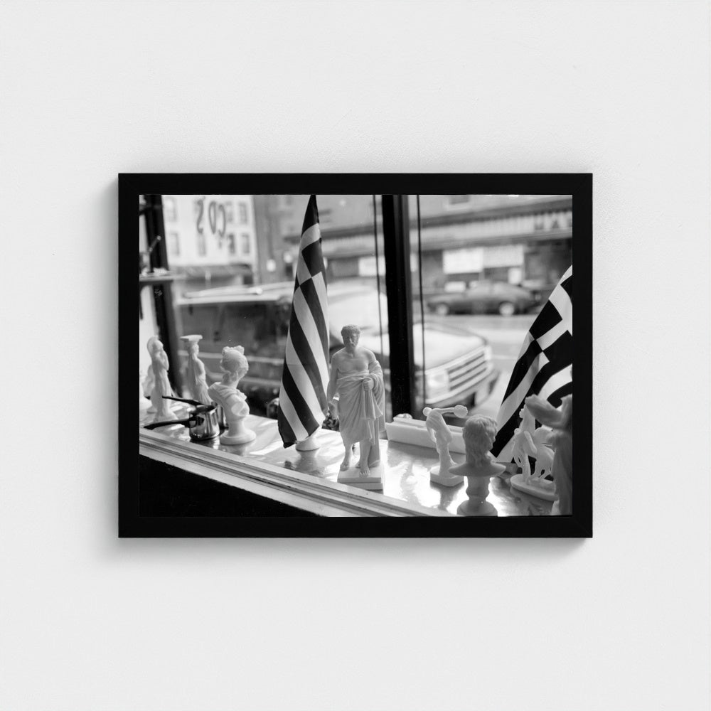 Greek Flags in the Shop Window — 12 × 16 inch black framed print