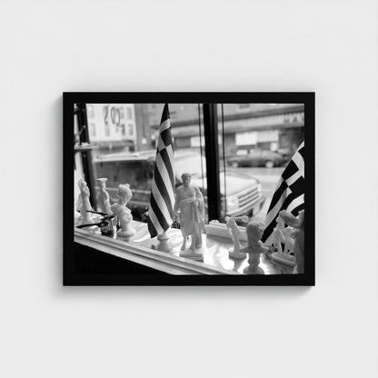 Greek Flags in the Shop Window — 12 × 16 inch black framed print