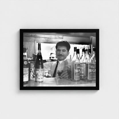 Pouring a Glass Behind the Counter — 12 × 16 inch black framed print