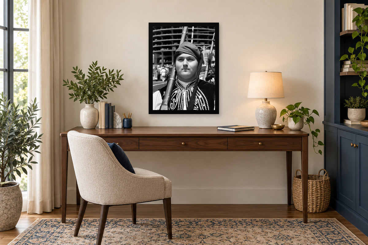 An Evzone at the Parade in a black frame, shown in an office setting — room visualization