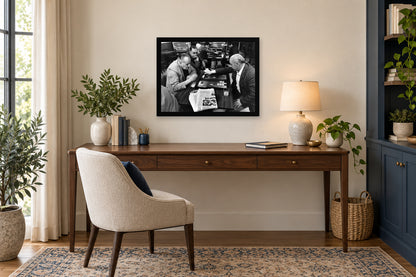 A Game at the Coffeehouse in a black frame, shown in an office setting — room visualization