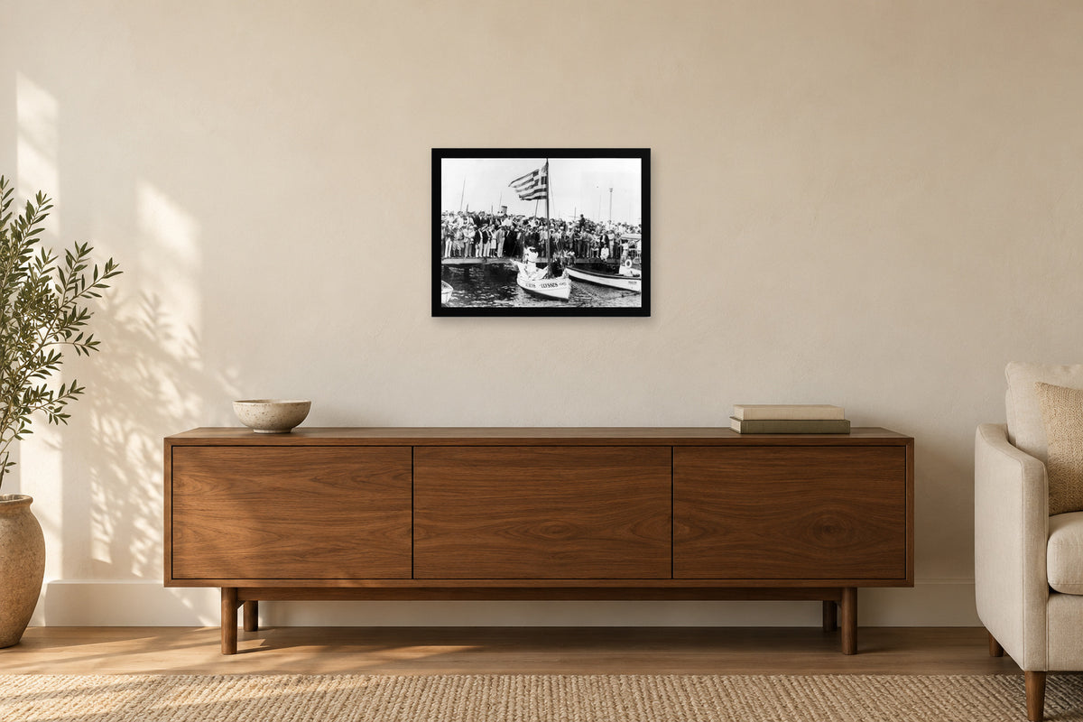 Crowds along the Waterfront in a black frame, shown in a home setting — room visualization