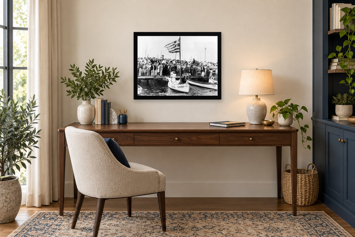 Crowds along the Waterfront in a black frame, shown in an office setting — room visualization