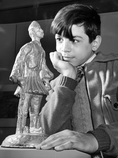 A Child with an Evzone Statuette — 12 × 16 inch art print