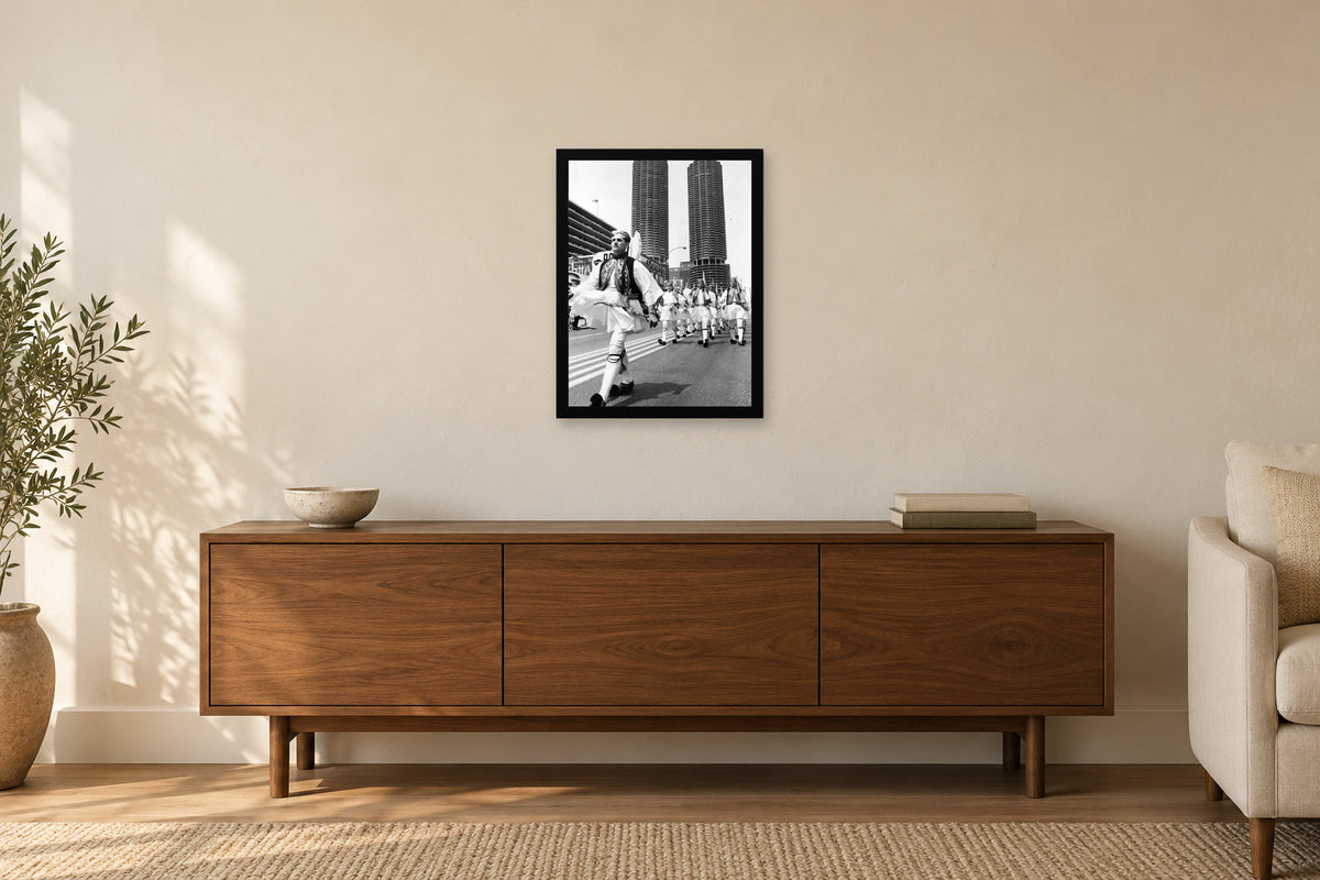 An Evzone Leads the Procession in a black frame, shown in a home setting — room visualization
