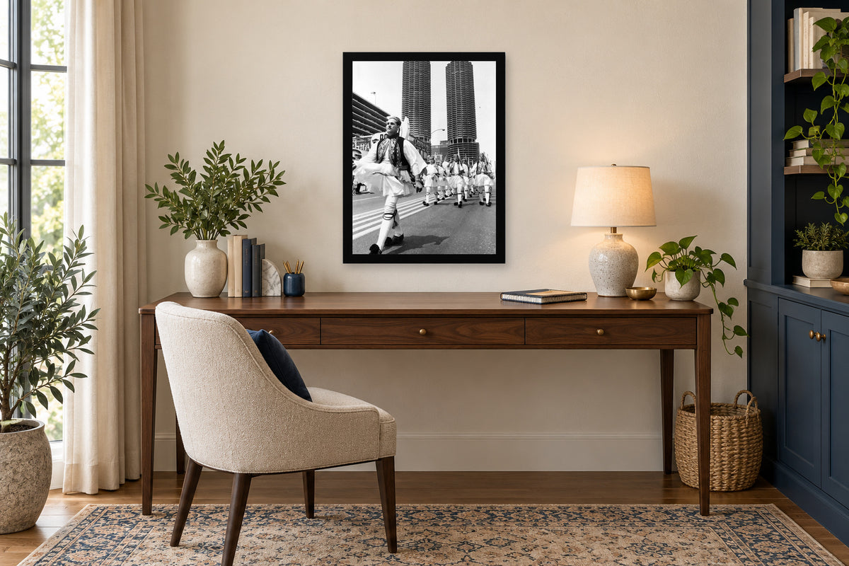 An Evzone Leads the Procession in a black frame, shown in an office setting — room visualization