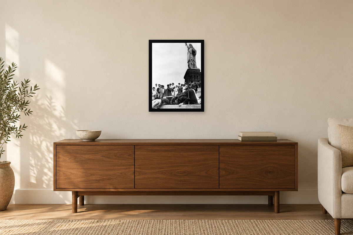 Visitors at the Statue of Liberty in a black frame, shown in a home setting — room visualization