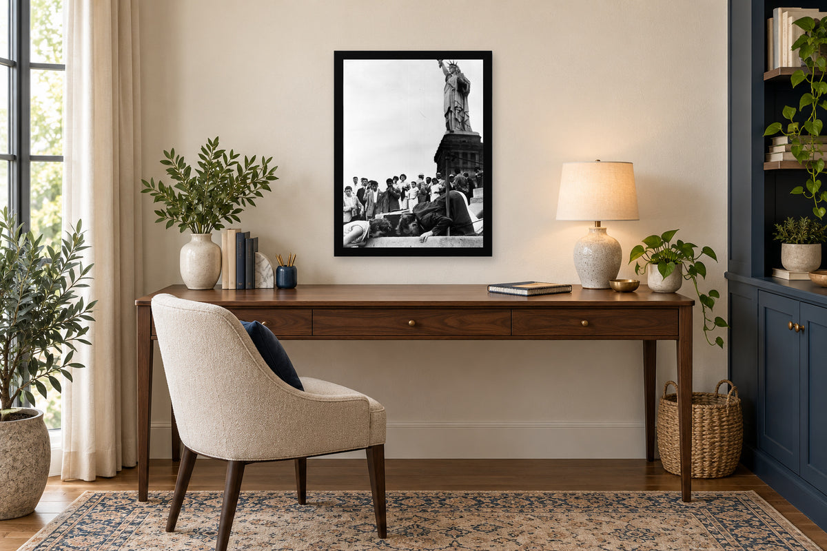 Visitors at the Statue of Liberty in a black frame, shown in an office setting — room visualization