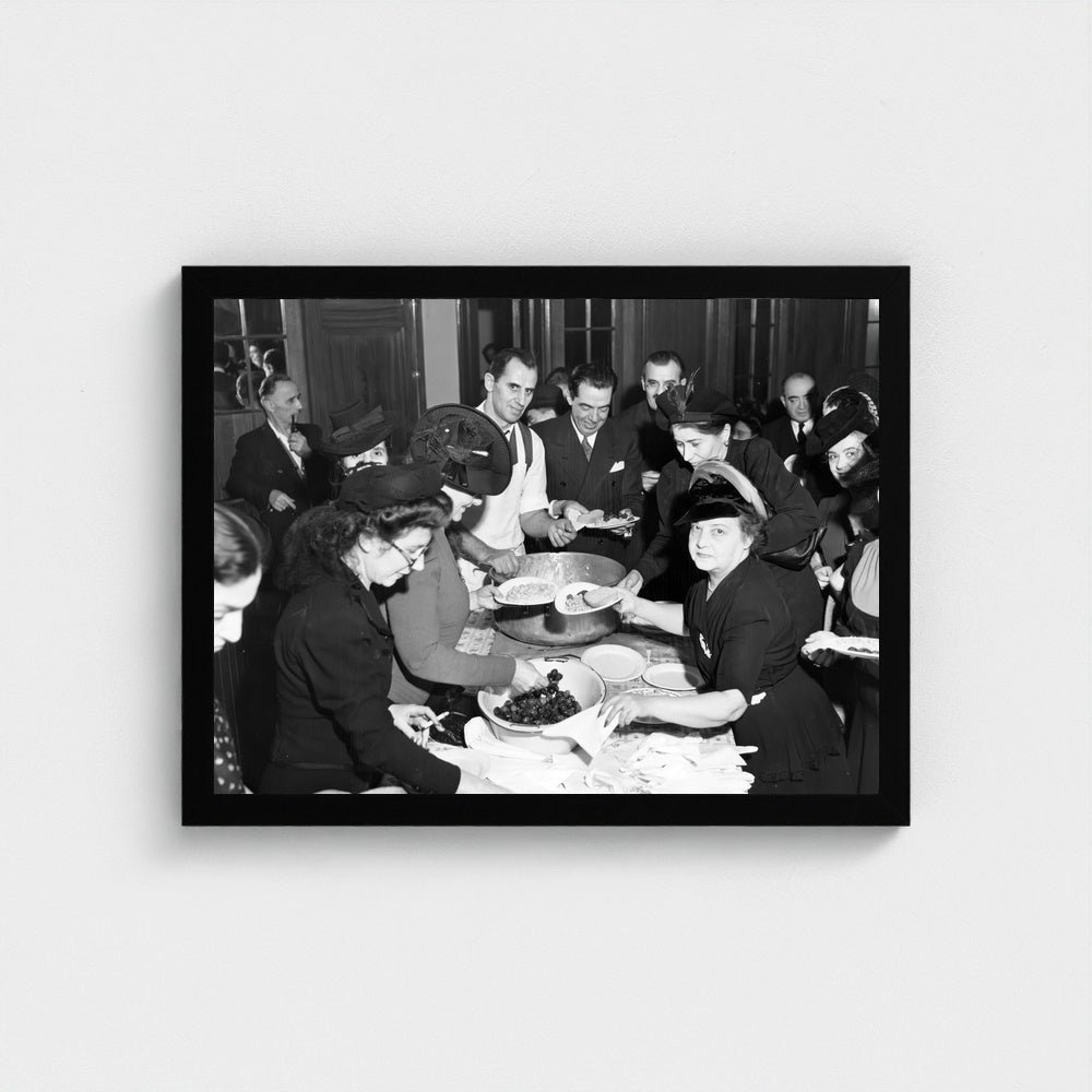 Sharing Food at a Community Gathering — 12 × 16 inch black framed print