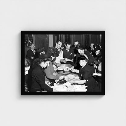 Sharing Food at a Community Gathering — 12 × 16 inch black framed print