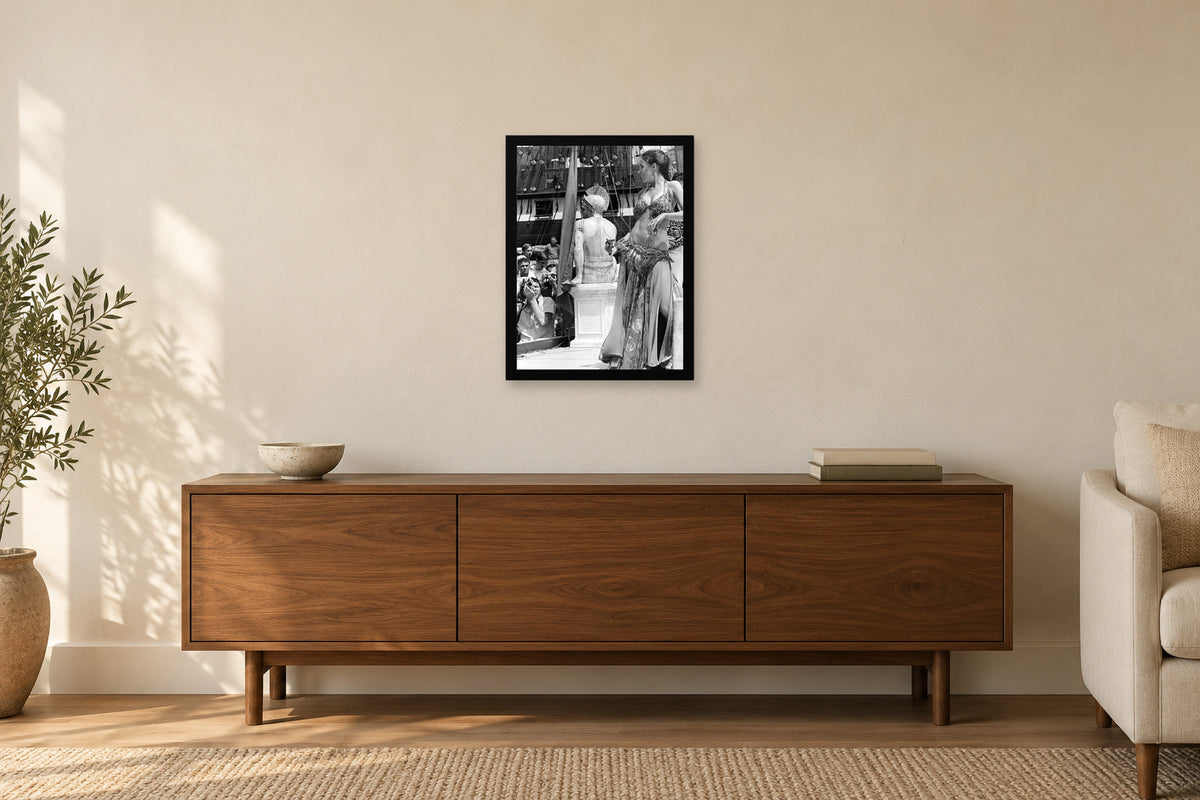 A Performer beside the Festival Stage in a black frame, shown in a home setting — room visualization