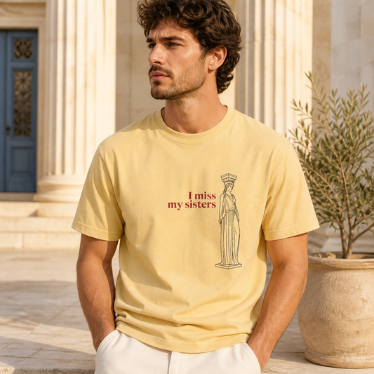 Caryatid I miss my sisters butter T-shirt worn in an Athens-inspired courtyard