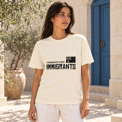 Granddaughter of Greek Immigrants — Australia — Ivory shirt worn by a model in a sunlit stone courtyard; AI-generated lifestyle mockup
