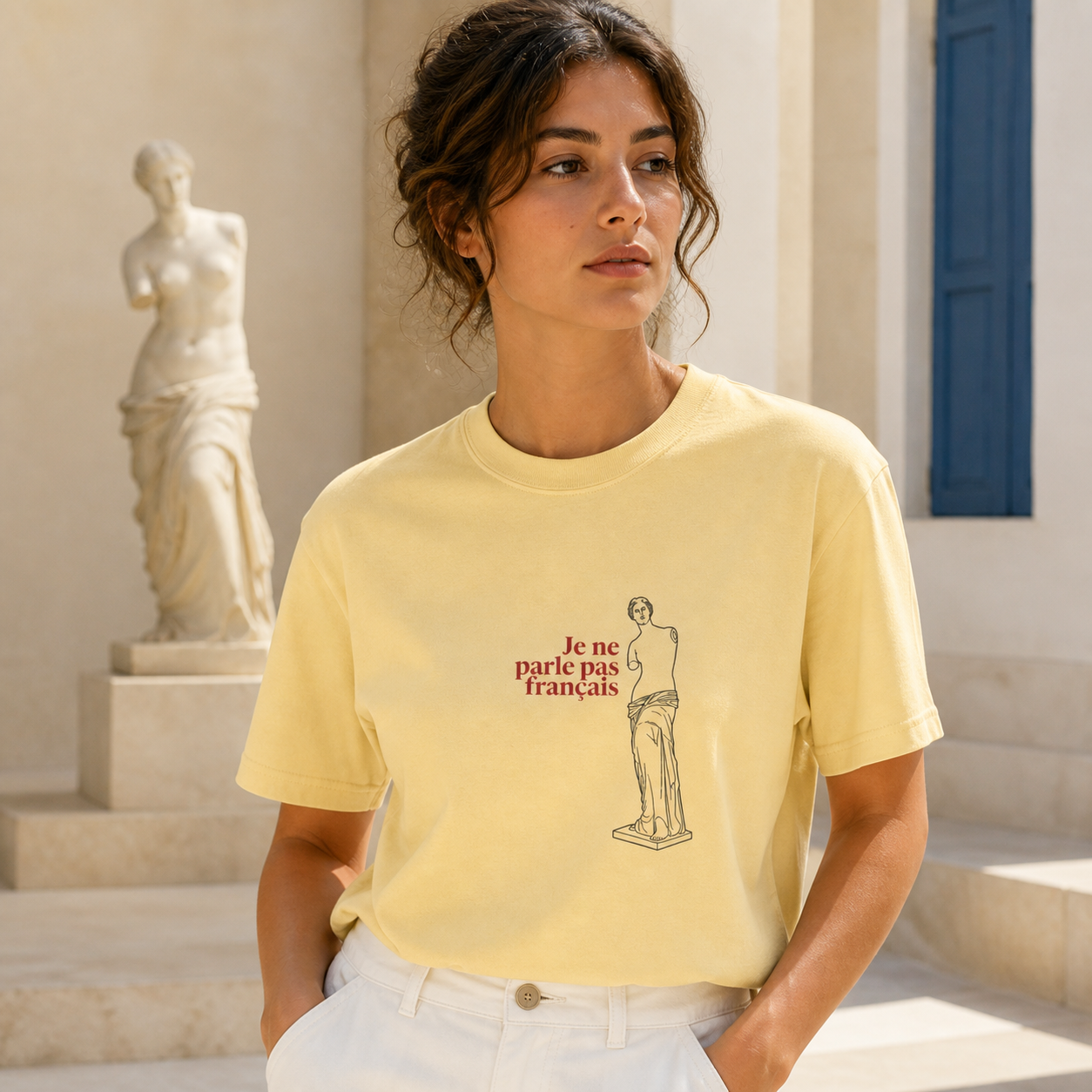Venus de Milo Je ne parle pas français butter T-shirt worn in a Mediterranean museum setting